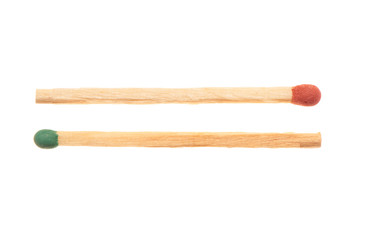 Green and red wooden matches lying in opposite directions