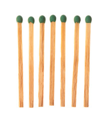 Set of seven green wooden matches isolated on white background