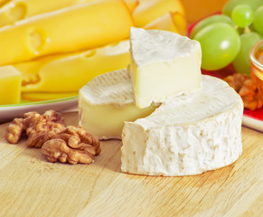 Still life with cheese, walnuts and grapes