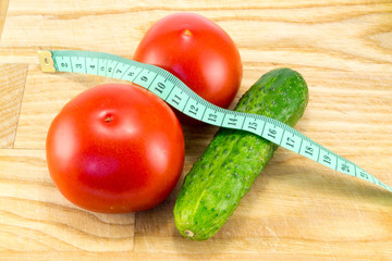 Cucumber and tomato with measuring