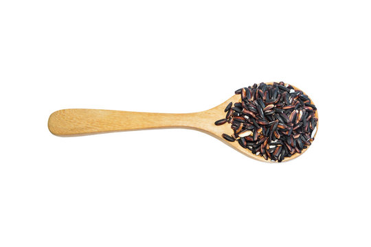 Black rice on wooden spoon isolated on white  background. Produc