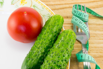 Measuring tape and a fork with tomato isolated