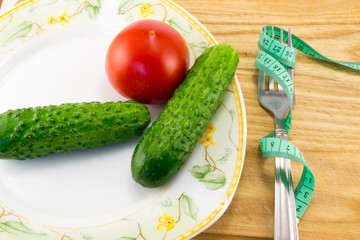 Measuring tape and a fork with tomato isolated