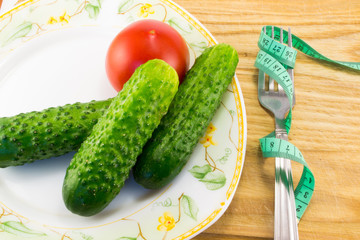 Cucumber and tomato with measuring