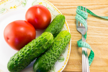 Cucumber and tomato with measuring