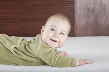 Fototapeta premium green onesie baby smiling