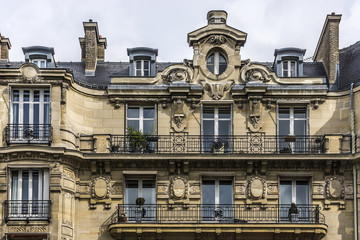 Fototapeta na wymiar Traditional French house: balconies and windows. Paris, France.