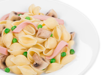 Pasta ribbons with vegetables on white plate.