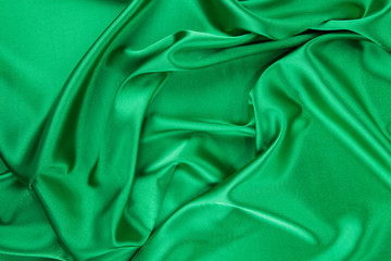 Green silk cloth with some folds.
