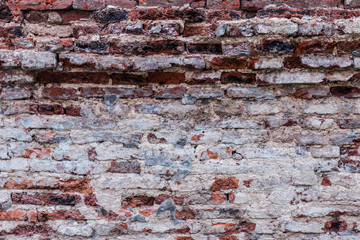 Old and weathered red brick wall
