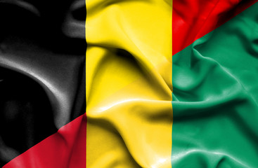 Obraz premium Waving flag of Guinea and Belgium