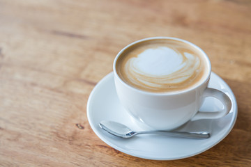 Coffee in white cup on wood table