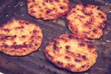 Hamburgers in a grill pan ( Filtered image processed vintage eff