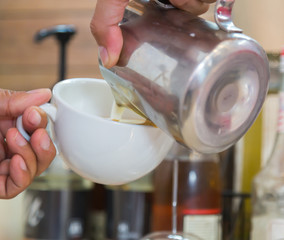 Fototapeta na wymiar Pouring milk to mix coffee