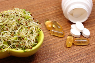Alfalfa and radish sprouts with tablets supplements, healthy nutrition