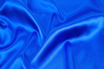 Soft folds of deep blue cloth texture.