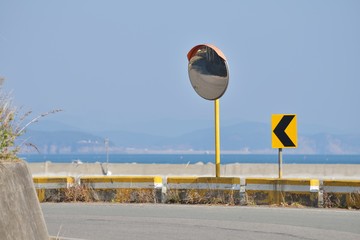 Two Arrow Curve Sign and Convex Mirror on road