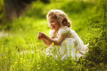 Funny happy little girl with a flower