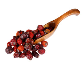 Berries dried rosehips in the wooden spoon, isolated on white ba