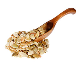 Pumpkin seeds in the wooden spoon, isolated on white background.