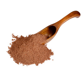 Nutmeg powder in the wooden spoon, isolated on white background.