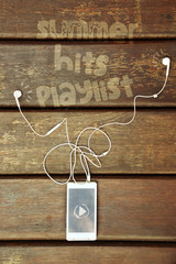 White tablet and headphones on wooden background