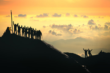 Teamwork. A group of people are standing on the top of the mountain.  - 85926554