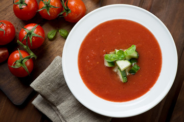 Gazpacho with cucumber and green basil topping, above view
