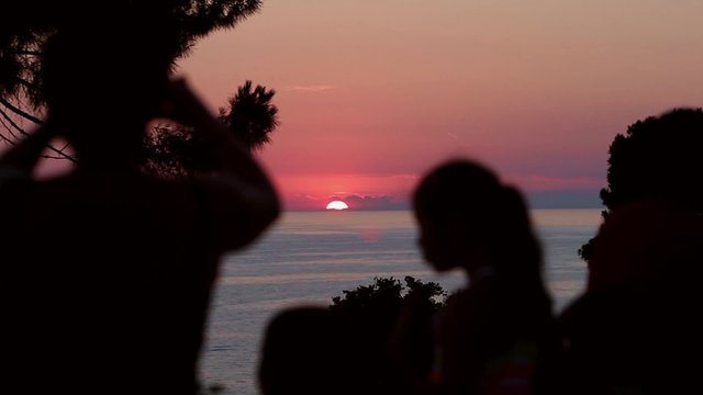 People watching a sunset at Adriatic sea in Rovinj, Croatia.