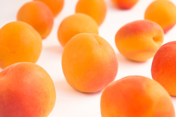 Apricots in Random Arrangement on White Surface