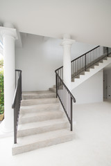 Stone staircase with black iron handrails