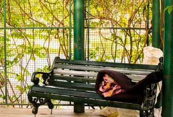 Mattress put on bench by homeless person