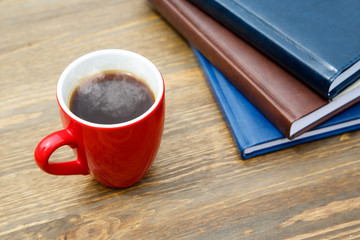Cup of coffee and notepad