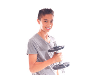 smiling Asian European teenage boy exercising with a dumbbell