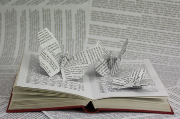 Origami butterflies coming out of a book