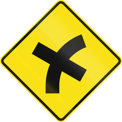 Obraz premium Australian road warning sign - 4 way intersection in curve ahead