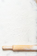 Sifted flour and rolling pin on the table. Kitchen background