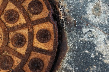 Obraz na płótnie Canvas closeup of round shape rusty manhole