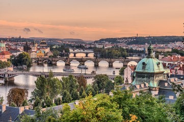 Fototapeta na wymiar Bridges over Vltava river in Prague at evening during sunset