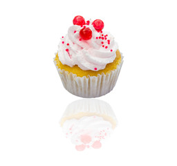 Cupcake with whipped cream and  isolated on white