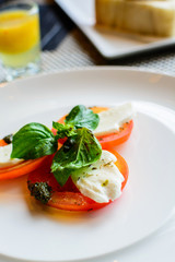 Tomato and mozzarella with basil leaves