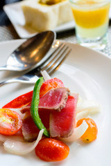 Tuna nicoise style salad on white plate