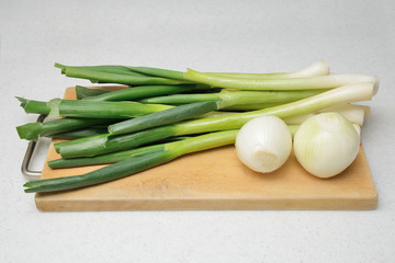 closeup of cleaned onion and green onion