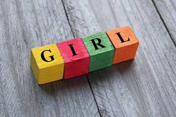 word girl on colorful wooden cubes