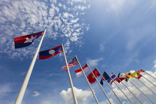 ASEAN flag and national flags of Southeast Asia countries on beautiful blue sky background