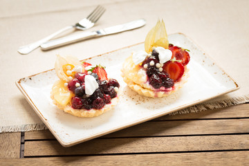 Fruit tarts on a wooden background