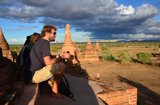 Traveler wait shooting photo sunset with Ancient City Bagan, Myanmar