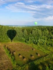 Hot air balloon over the field with blue sky