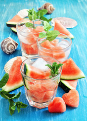 Refreshing watermelon drink with mint and ice cubes. Selective focus