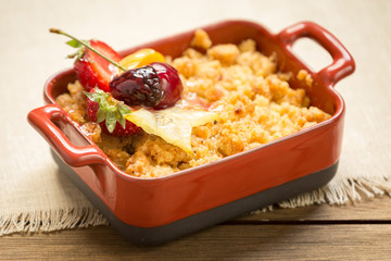 Apple crumble on a wooden background